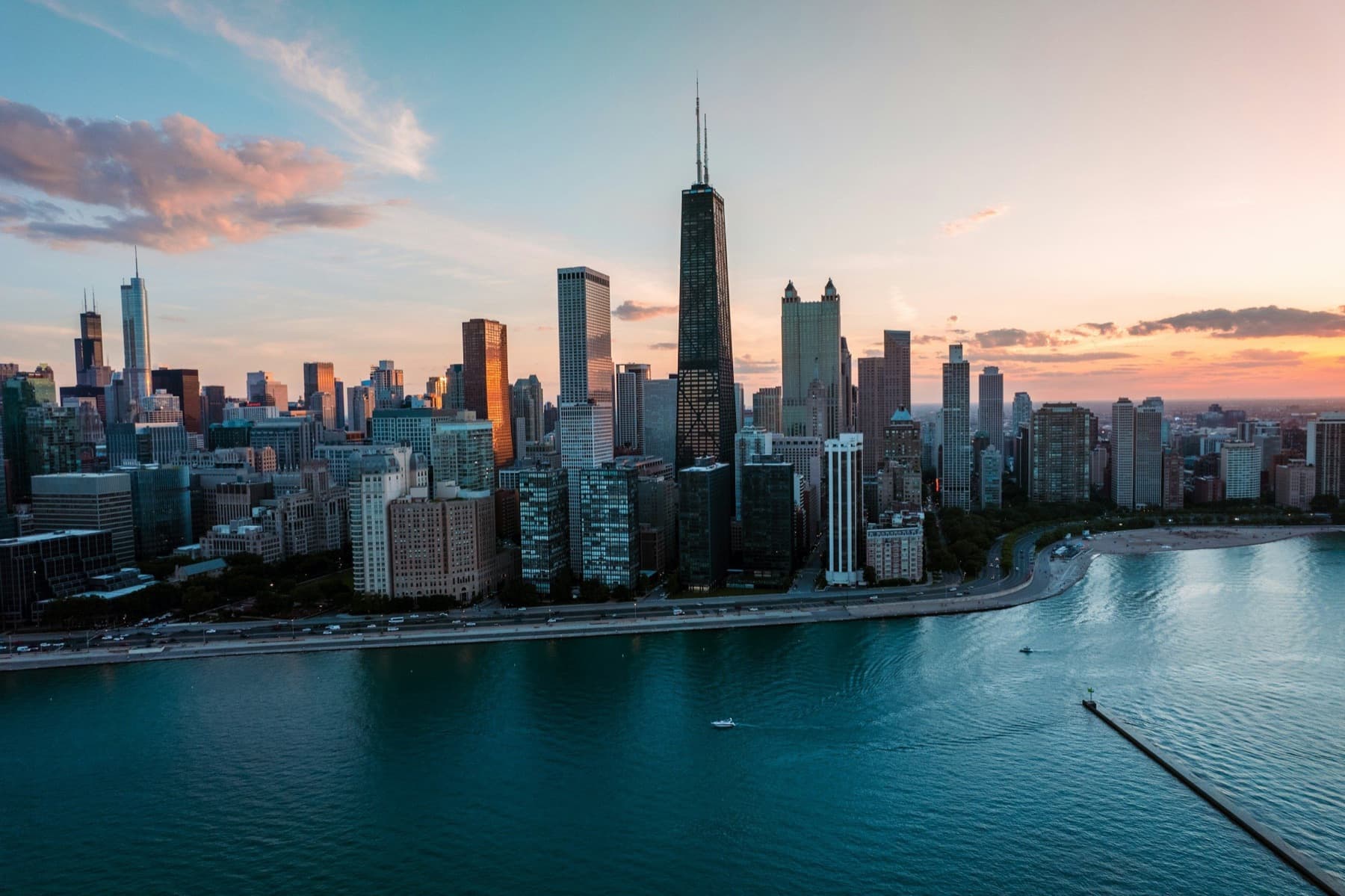 Chicago's skyline rises above the Lake Michigan shoreline at sunset